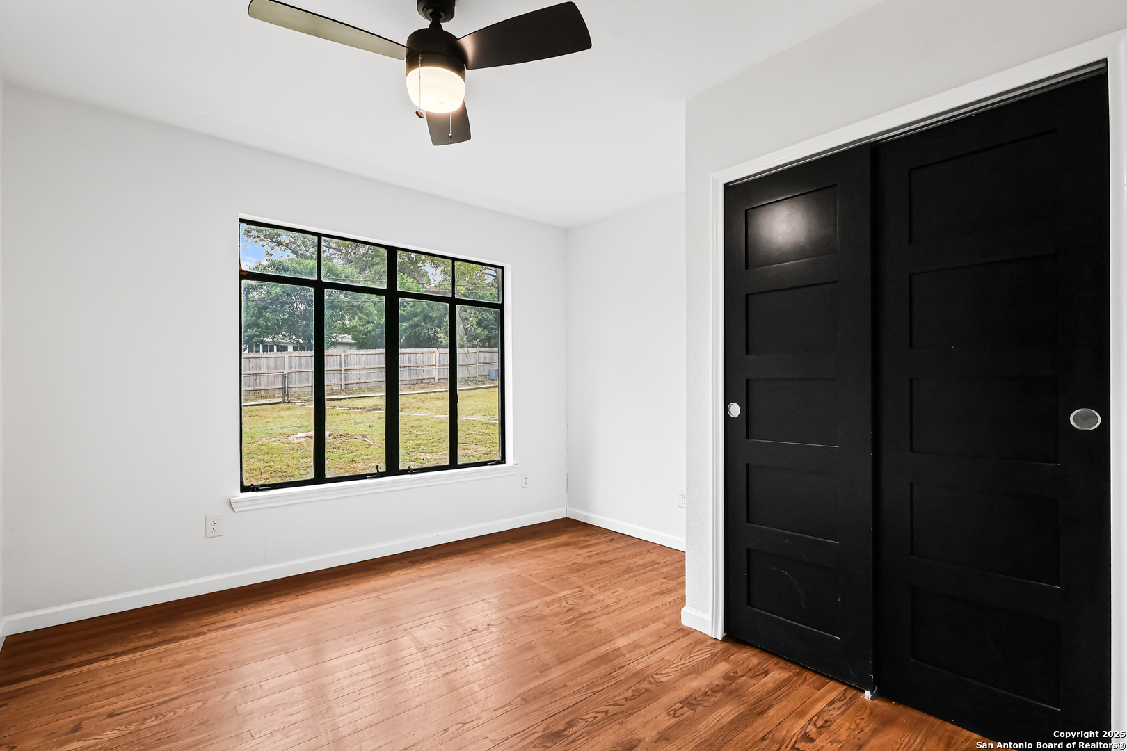 728 Rittiman Road San Antonio, TX 78209 - Photo 17 of 31 an empty room with wooden floor cabinet and windows