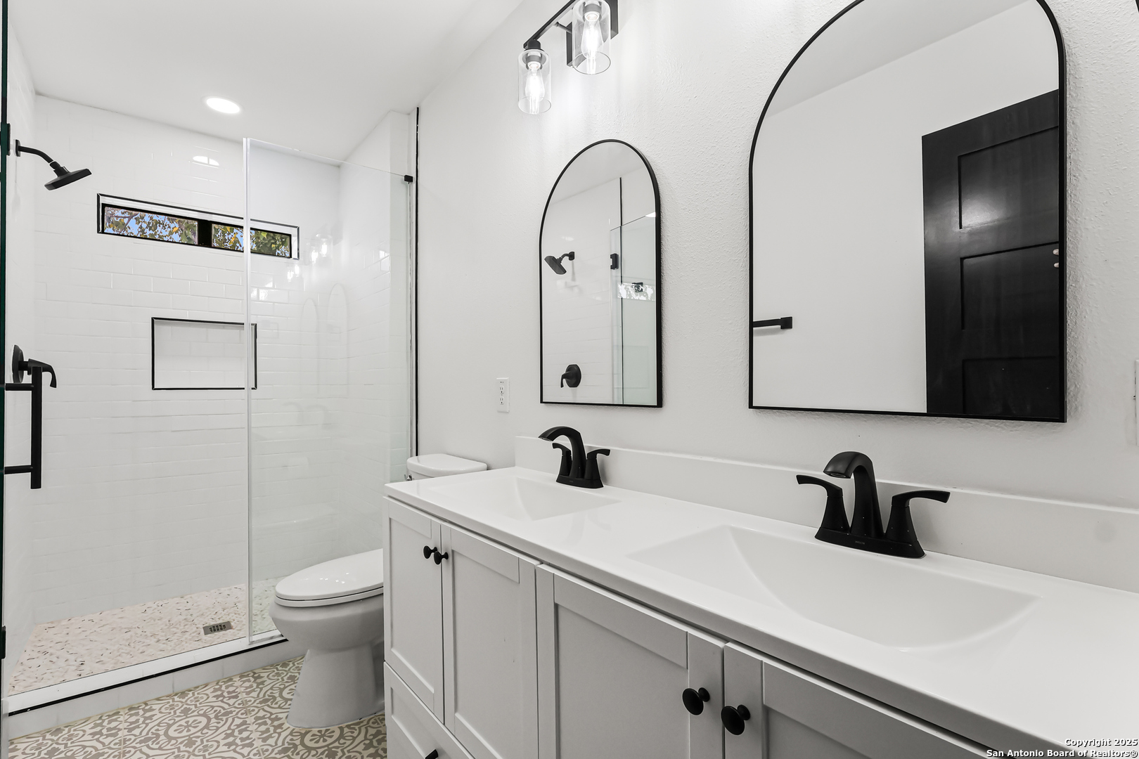 728 Rittiman Road San Antonio, TX 78209 - Photo 19 of 31 a bathroom with a sink a toilet and a mirror