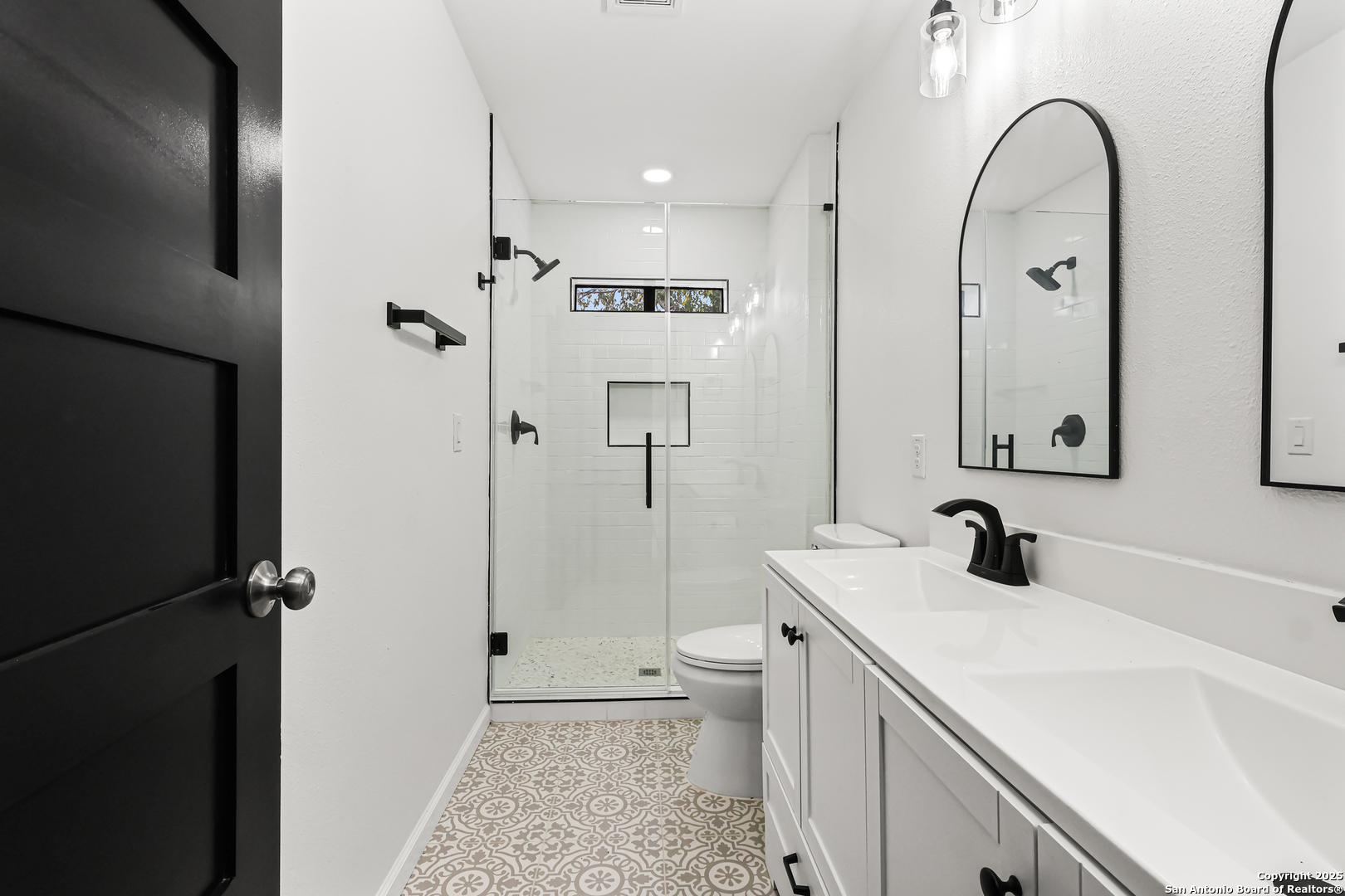 728 Rittiman Road San Antonio, TX 78209 - Photo 20 of 31 a bathroom with a double vanity sink toilet and shower