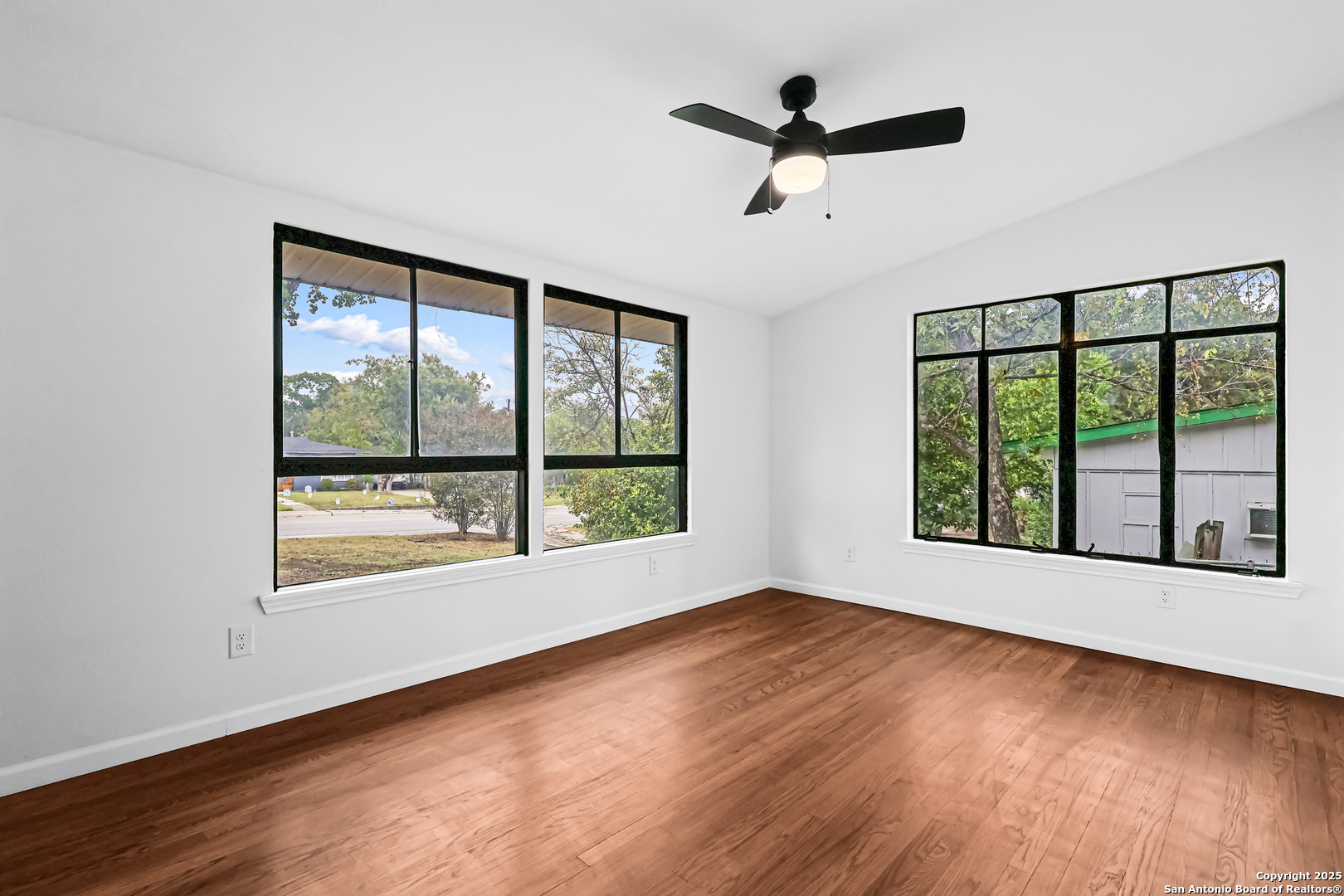 728 Rittiman Road San Antonio, TX 78209 - Photo 21 of 31 a view of an empty room with wooden floor and a window