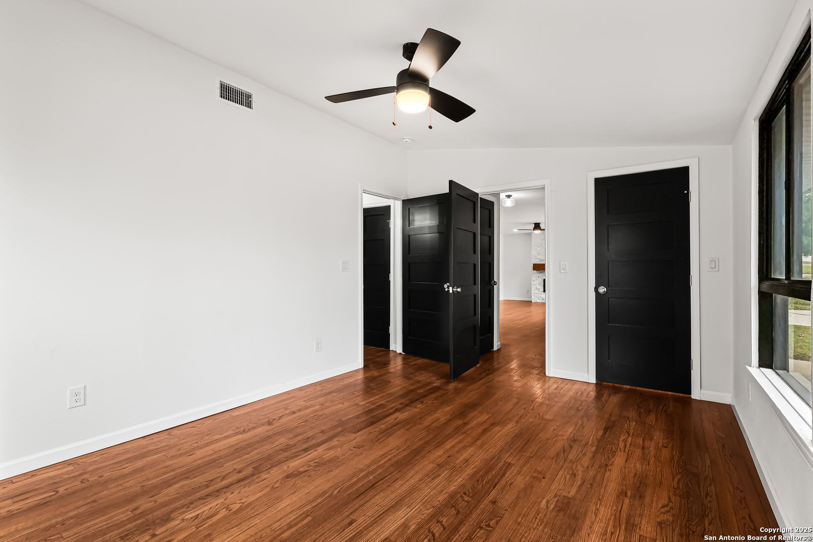 728 Rittiman Road San Antonio, TX 78209 - Photo 22 of 31 a view of an empty room with wooden floor