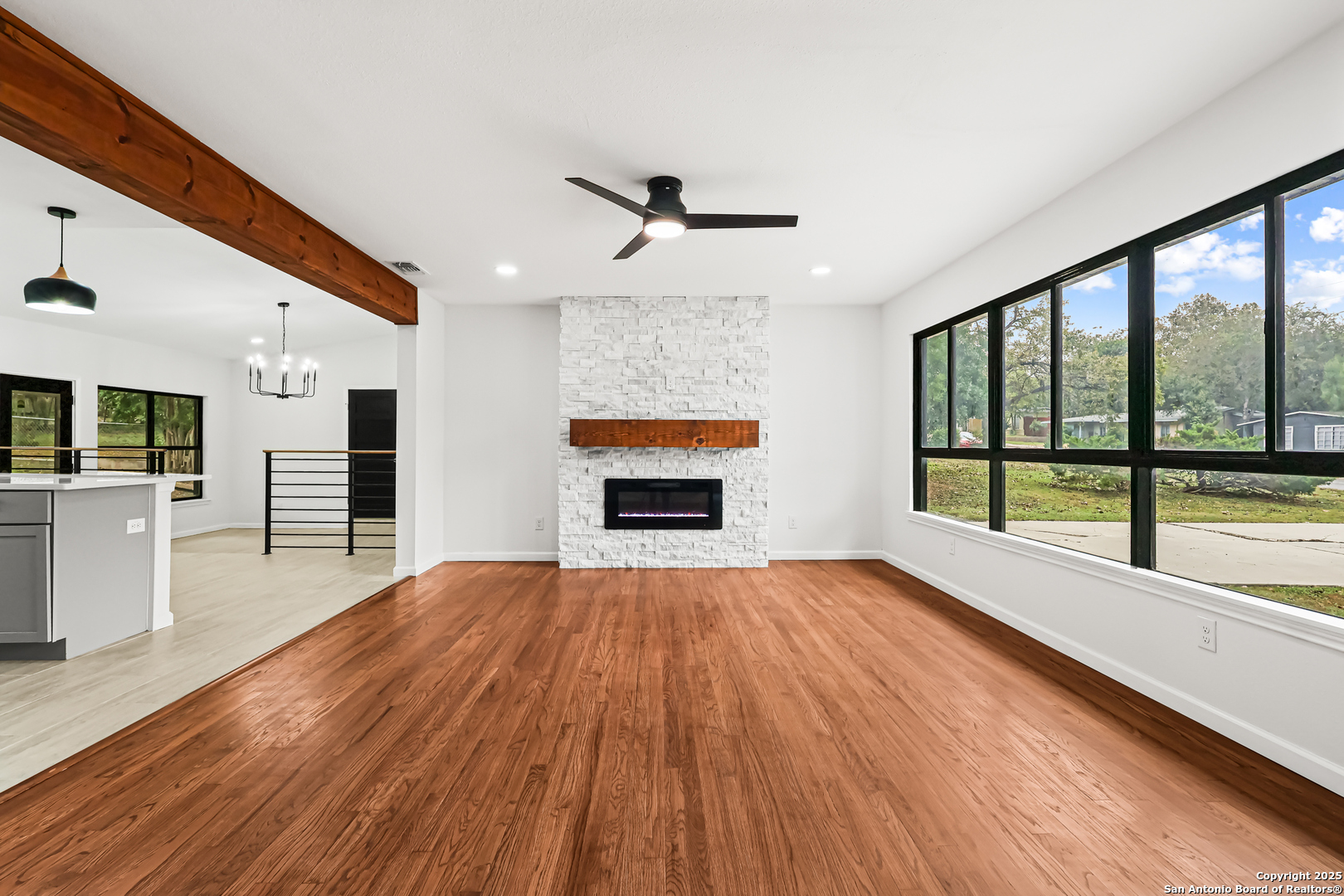 728 Rittiman Road San Antonio, TX 78209 - Photo 23 of 31 wooden floor fireplace and windows in an empty room