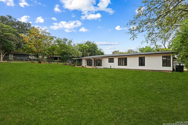 a view of a house with a backyard