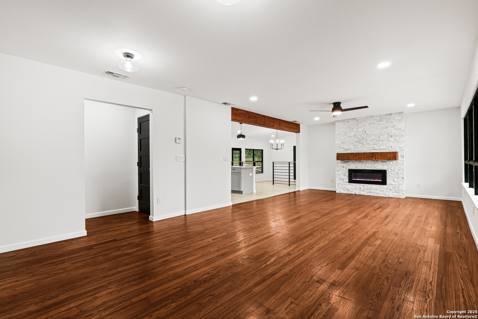 728 Rittiman Road San Antonio, TX 78209 - Photo 5 of 31 a view of empty room with wooden floor and fireplace