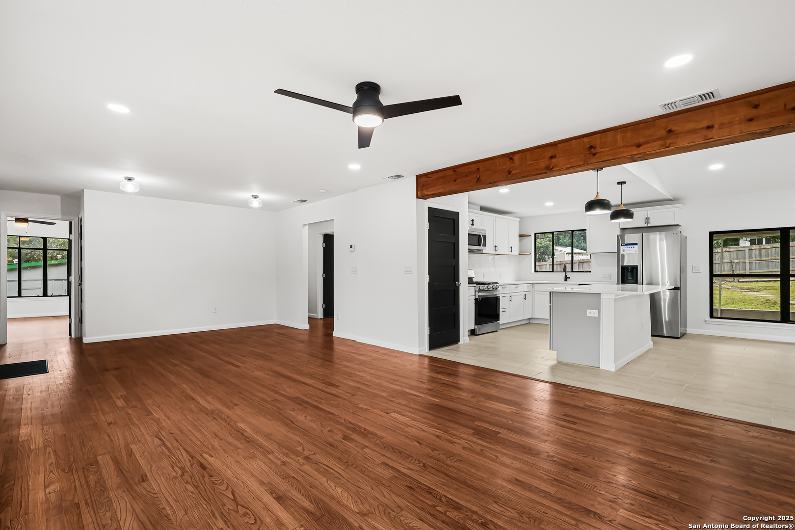 728 Rittiman Road San Antonio, TX 78209 - Photo 6 of 31 a view of a big room with wooden floor and windows