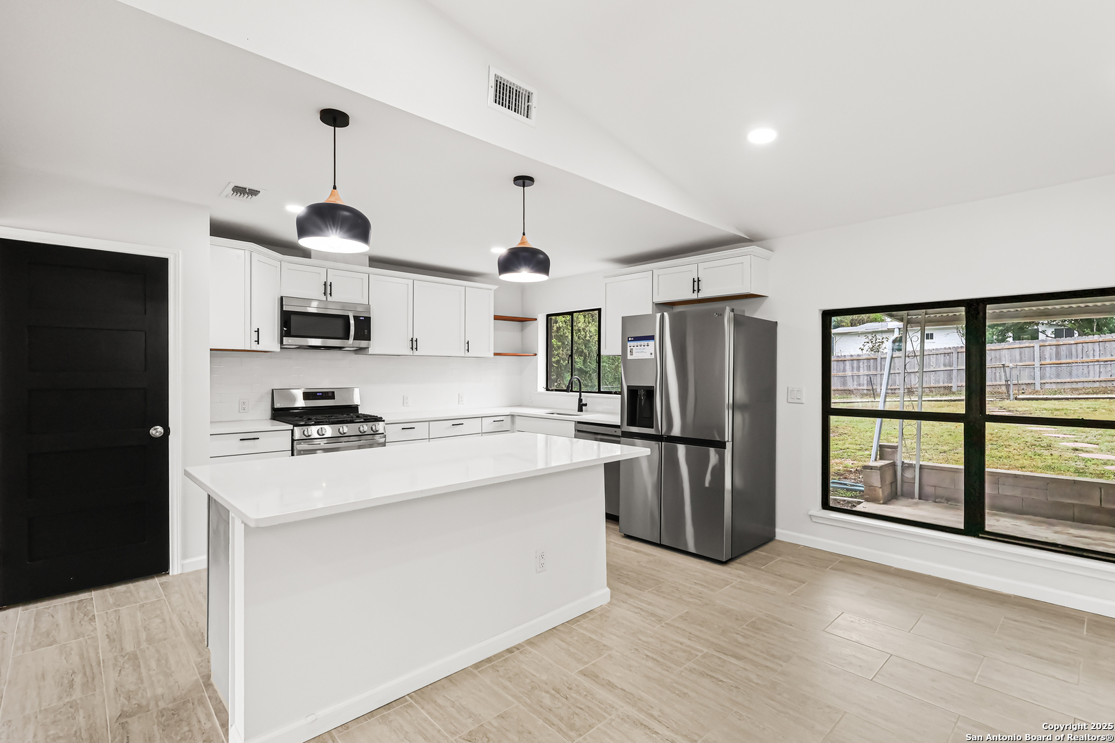 728 Rittiman Road San Antonio, TX 78209 - Photo 9 of 31 a kitchen with stainless steel appliances a refrigerator sink and stove