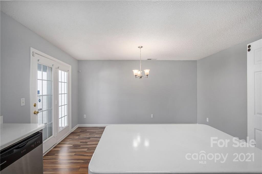 3228 Barons Court Road Charlotte, NC 28213 - Photo 9 of 19 a view of a livingroom with wooden floor and kitchen space