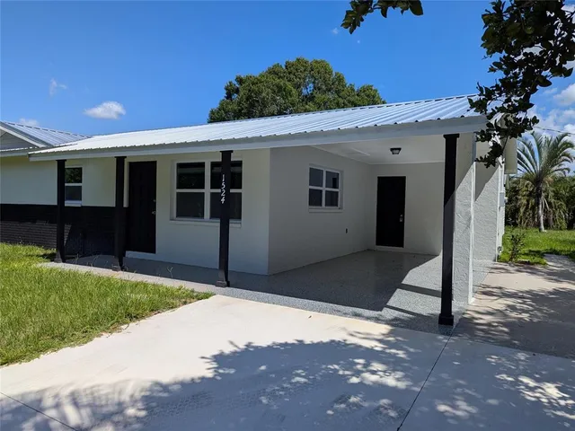 a front view of a house with a garden and yard