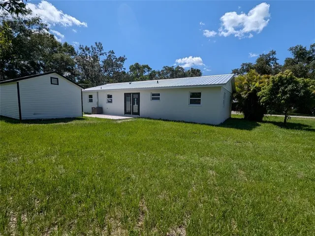 a front view of house with yard and trees