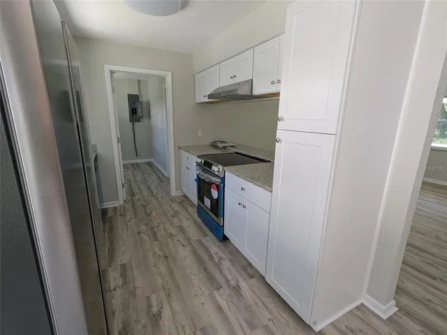 a kitchen with a sink a refrigerator and a stove