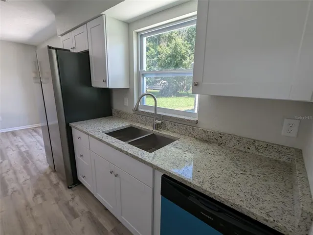 a view of an empty room and a window