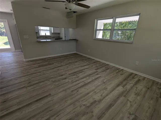 a bathroom with a granite countertop toilet a sink and a bathtub