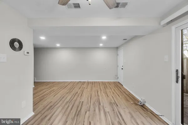 a view of a room with wooden floor