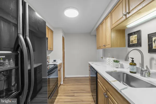 a kitchen with a sink cabinets and stainless steel appliances