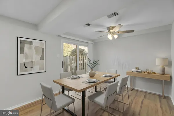 a view of a dining room with furniture and a chandelier