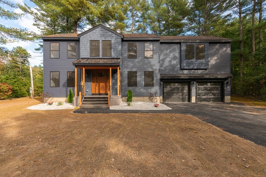 129 Lowell Road Pepperell, MA 01463 - Photo 1 of 39 a front view of a house with a garage