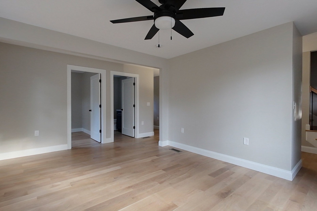 129 Lowell Road Pepperell, MA 01463 - Photo 13 of 39 a view of a room with a ceiling fan and hardwood floor