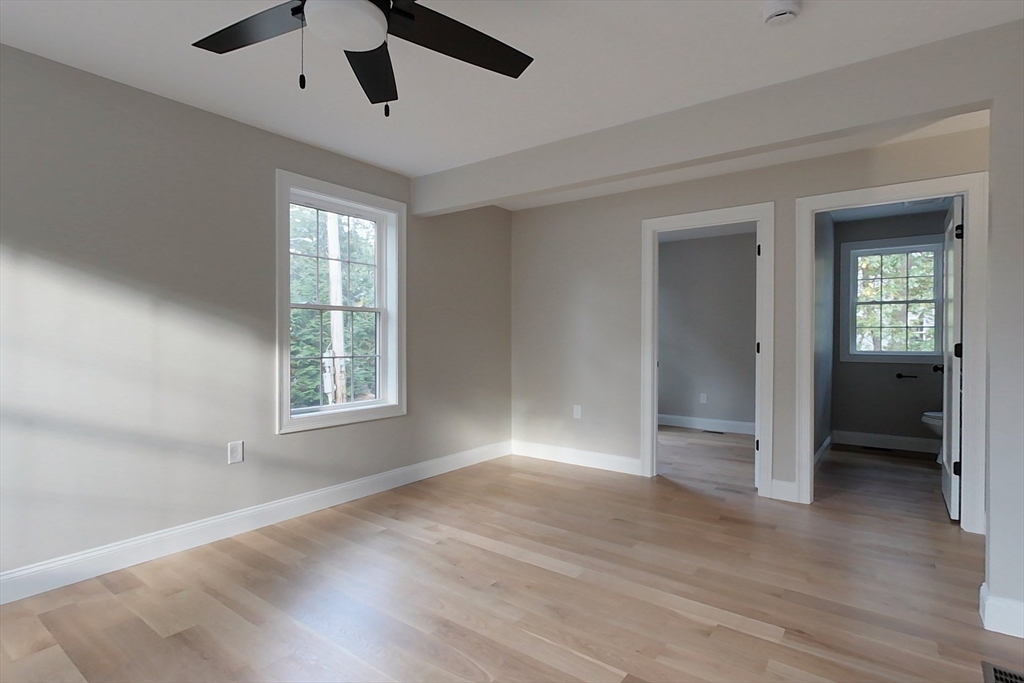 129 Lowell Road Pepperell, MA 01463 - Photo 14 of 39 an empty room with wooden floor cabinet and windows