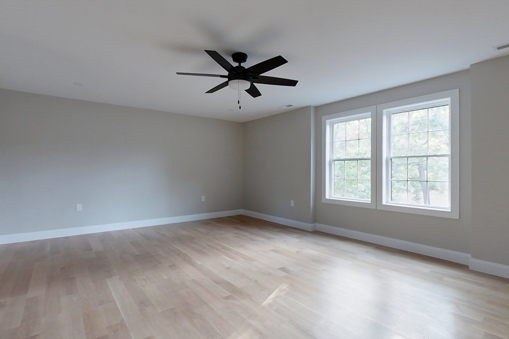 129 Lowell Road Pepperell, MA 01463 - Photo 20 of 39 an empty room with a window and a fan