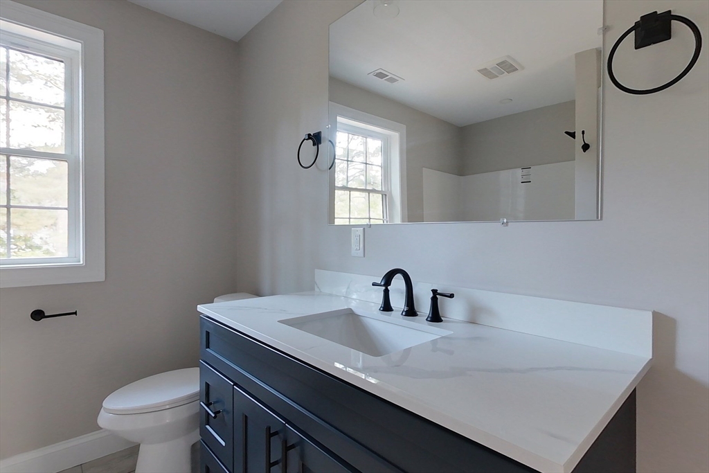 129 Lowell Road Pepperell, MA 01463 - Photo 29 of 39 a bathroom with a sink toilet and window