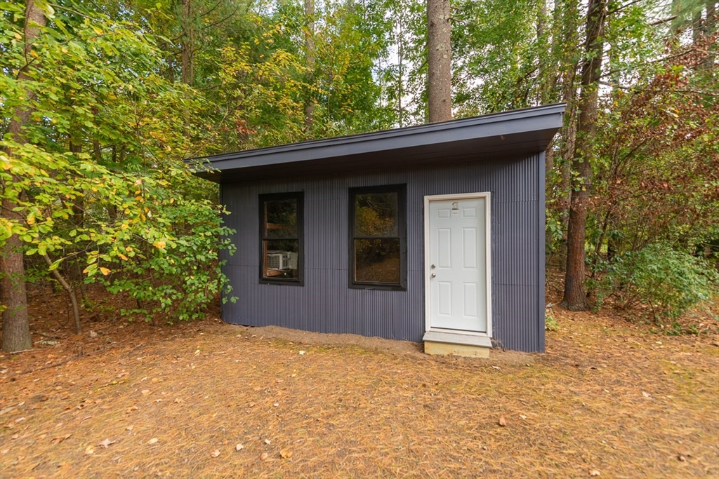 129 Lowell Road Pepperell, MA 01463 - Photo 36 of 39 a house with trees in front of it