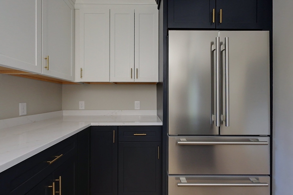 129 Lowell Road Pepperell, MA 01463 - Photo 5 of 39 a kitchen with a refrigerator and cabinets