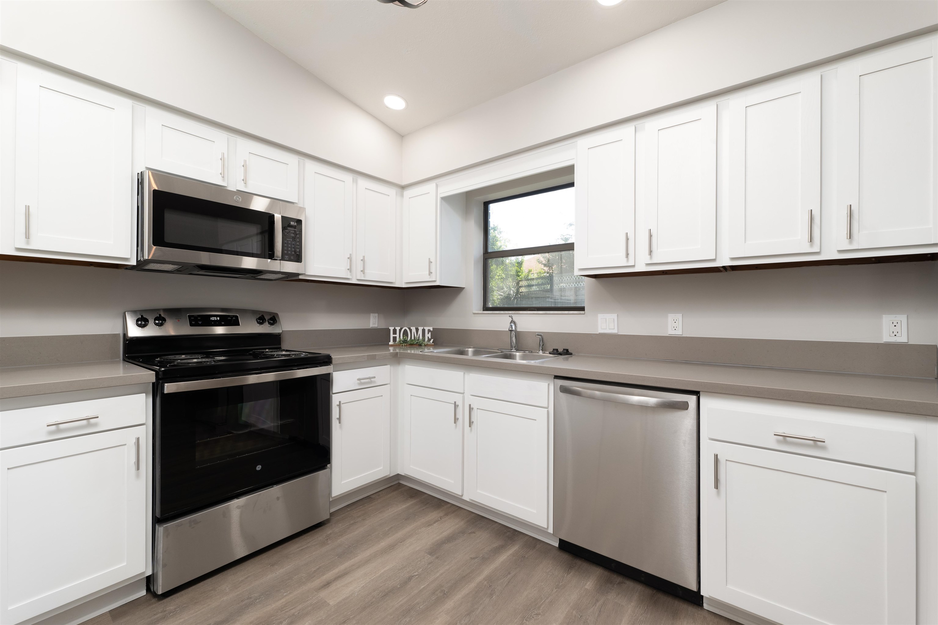 313 Cypress Road St. Augustine, FL 32086 - Photo 11 of 27 a kitchen with granite countertop white cabinets and stainless steel appliances