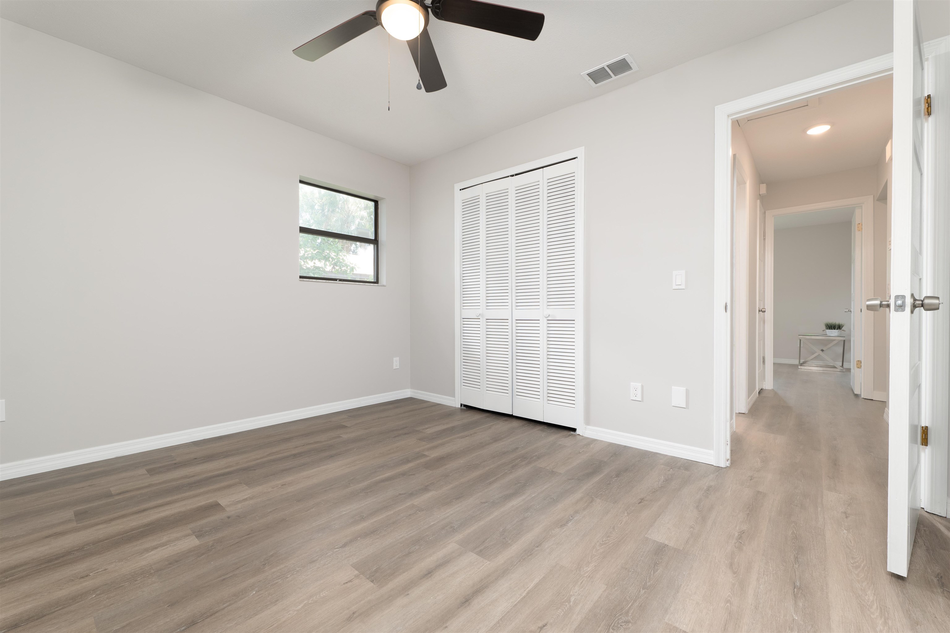 313 Cypress Road St. Augustine, FL 32086 - Photo 23 of 27 an empty room with wooden floor and windows