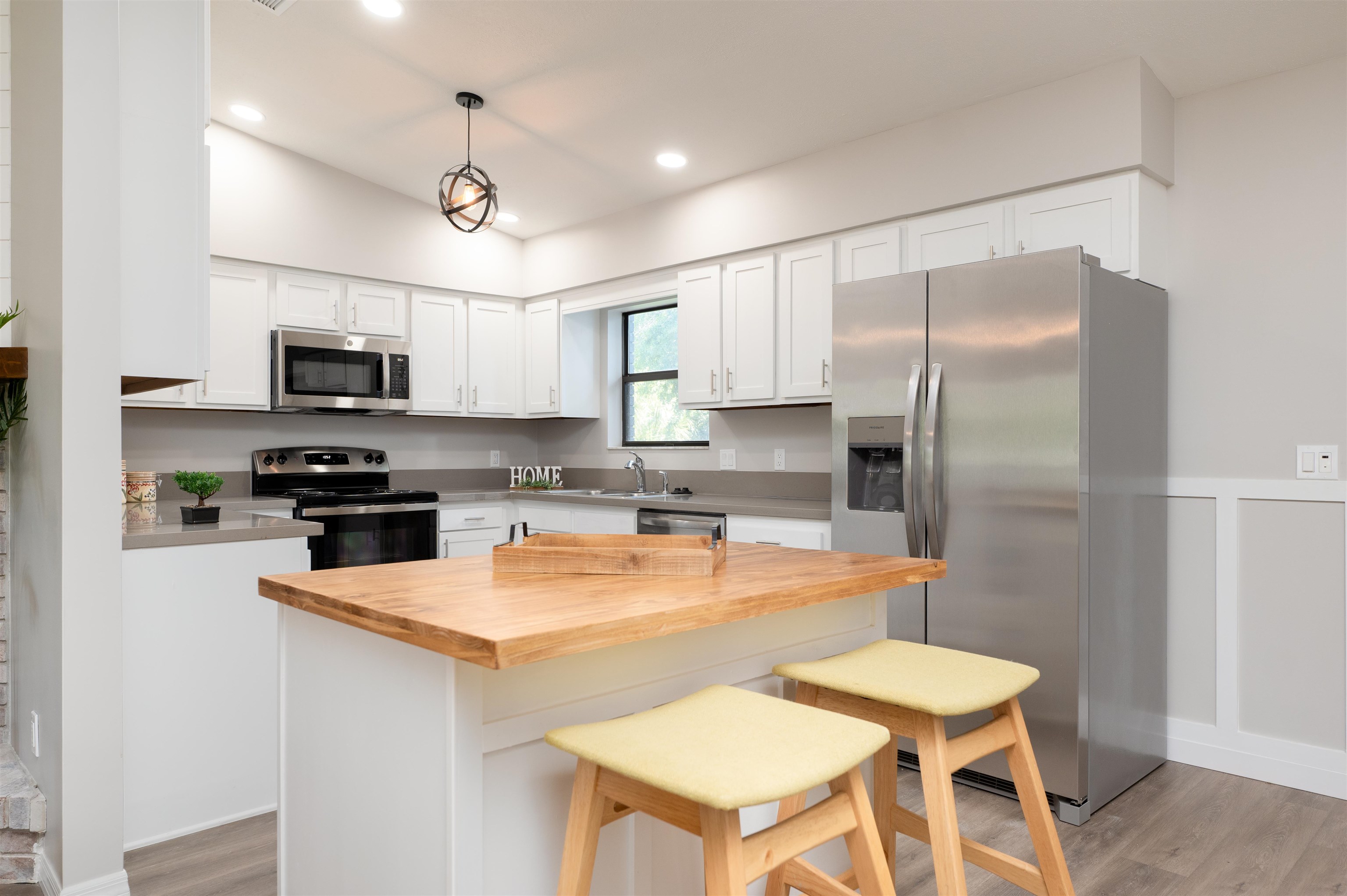 313 Cypress Road St. Augustine, FL 32086 - Photo 9 of 27 a kitchen with stainless steel appliances granite countertop a refrigerator a stove top oven a sink dishwasher a dining table and chairs