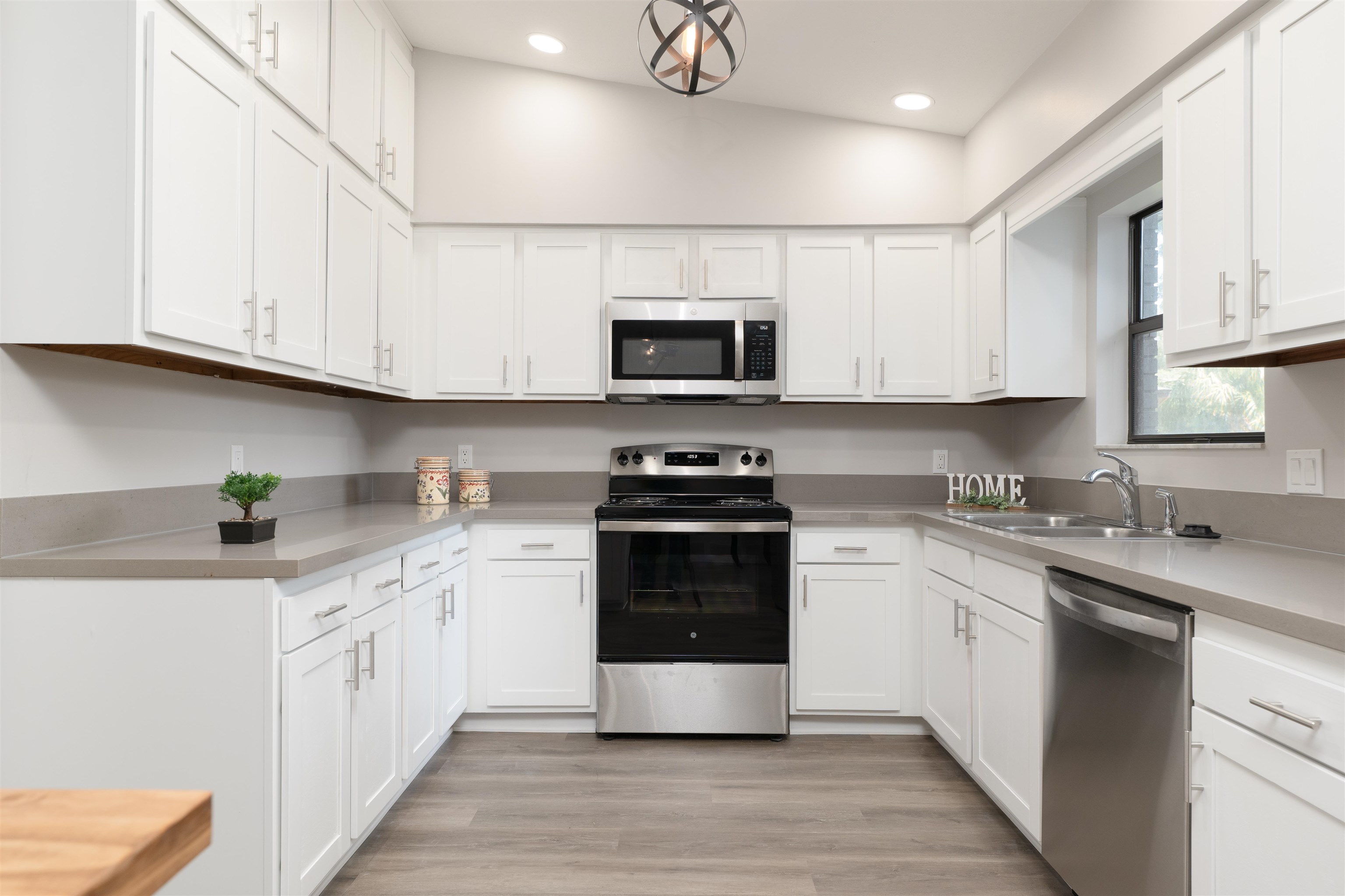 313 Cypress Road St. Augustine, FL 32086 - Photo 10 of 27 a kitchen with stainless steel appliances granite countertop a stove a sink and a microwave
