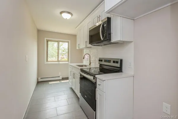a kitchen with stainless steel appliances granite countertop a sink and a stove