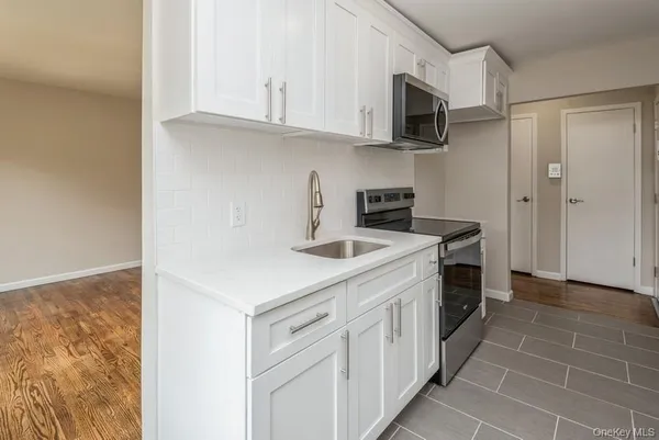 a kitchen with stainless steel appliances granite countertop a sink and a stove
