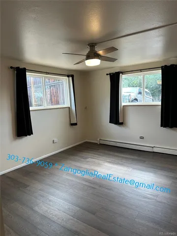 a view of a room with wooden floor and windows