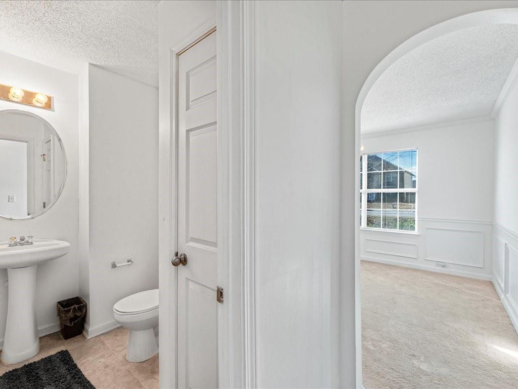 11950 Markham Way Hampton, GA 30228 - Photo 13 of 32 a bathroom with a toilet a sink and a window