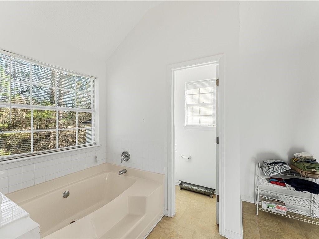 11950 Markham Way Hampton, GA 30228 - Photo 19 of 32 a bathroom with a tub and a window