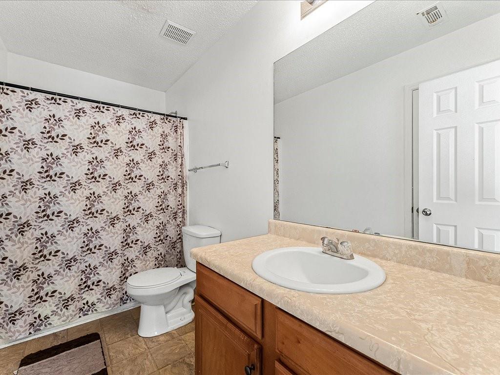 11950 Markham Way Hampton, GA 30228 - Photo 21 of 32 a bathroom with a sink toilet and a mirror