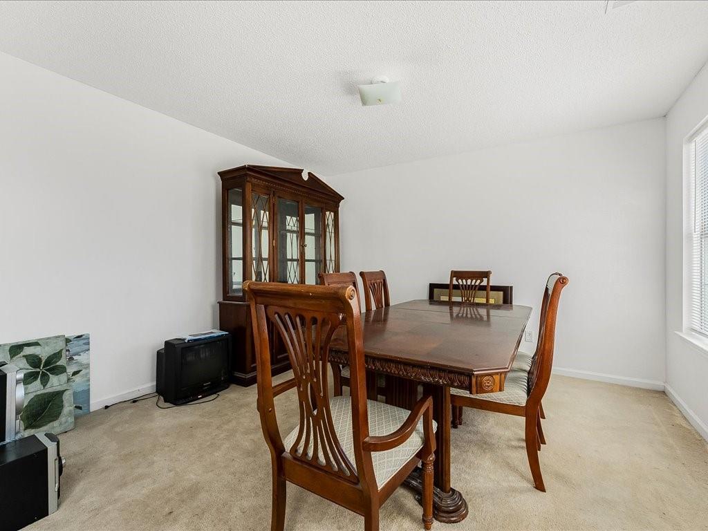 11950 Markham Way Hampton, GA 30228 - Photo 7 of 32 a view of a dining room with furniture and a potted plant