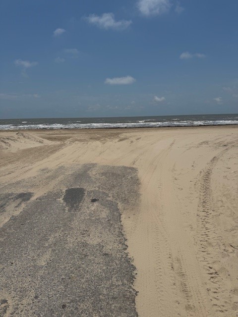 0 Crystal Beach Road Crystal Beach, TX 77650 - Photo 7 of 18 A serene beach view with sandy shores meeting the ocean under a clear blue sky. Perfect for seaside living.