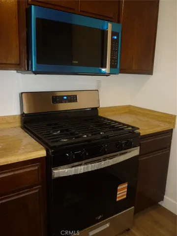 a stove top oven sitting inside of a kitchen