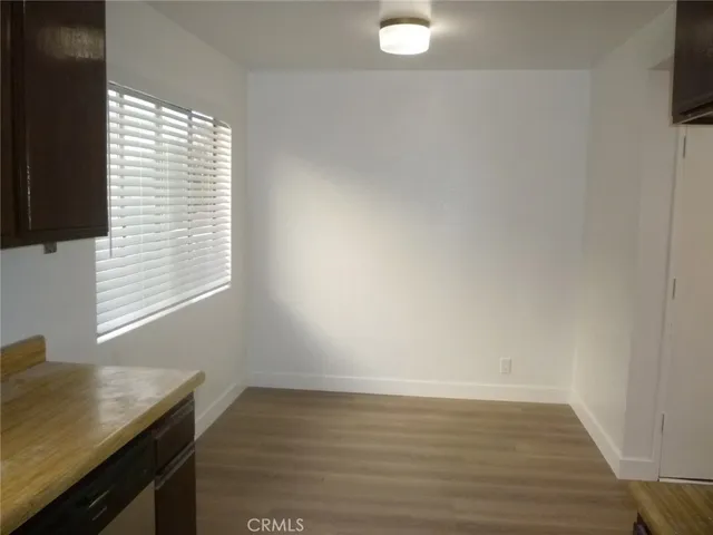 a view of workspace with wooden floor and window