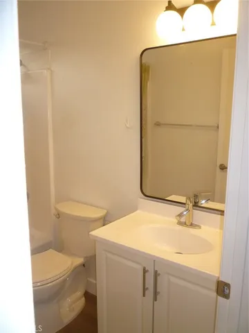 a bathroom with a sink a toilet and mirror