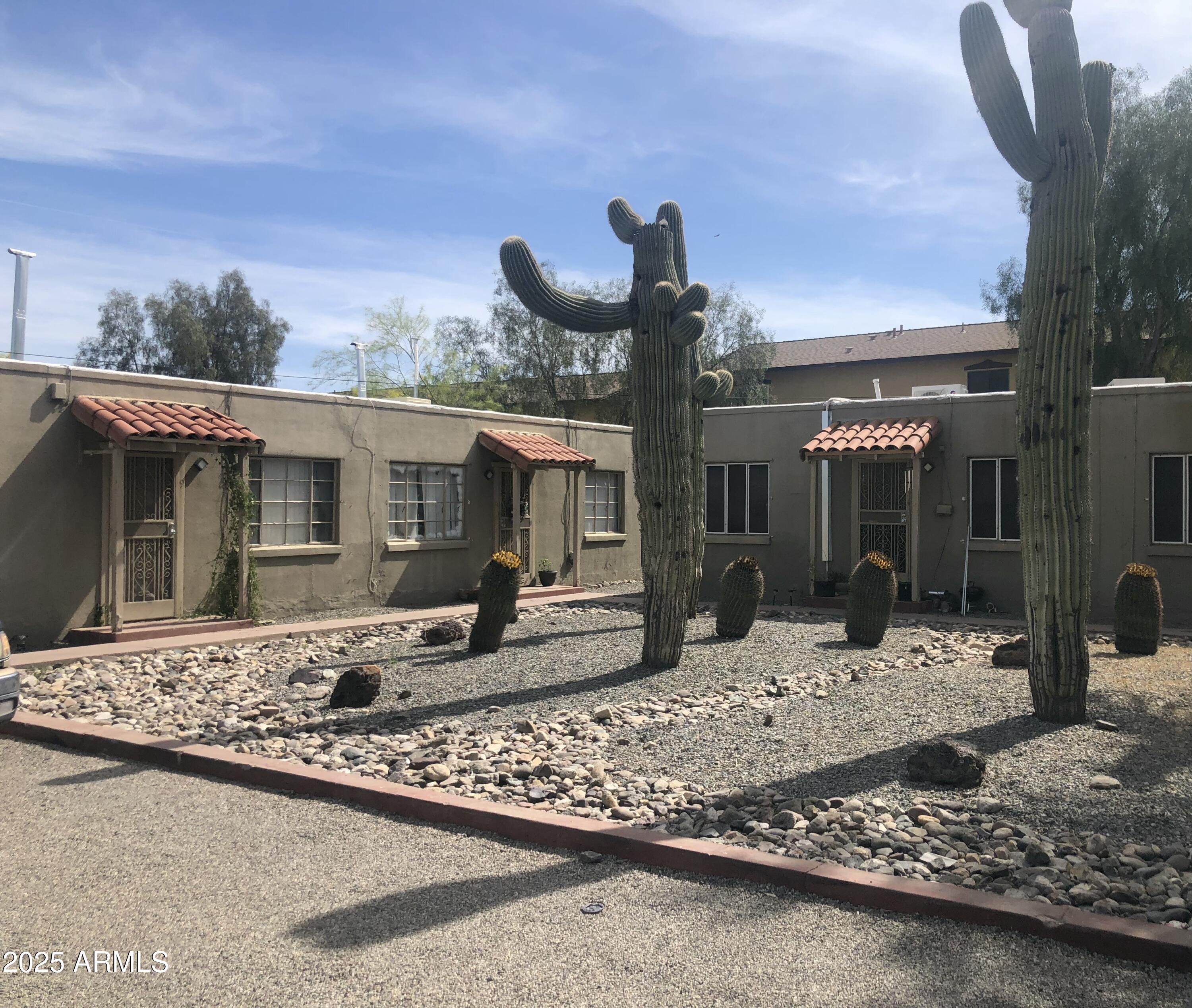 2620 North Stone Avenue Tucson, AZ 85705 - Photo 4 of 12 front view of a house with a chairs in patio