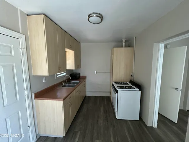 a kitchen with a sink stove and refrigerator