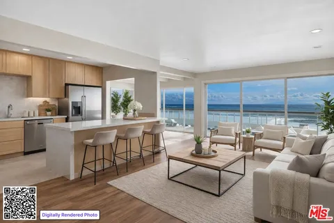 a living room with furniture a rug and kitchen view