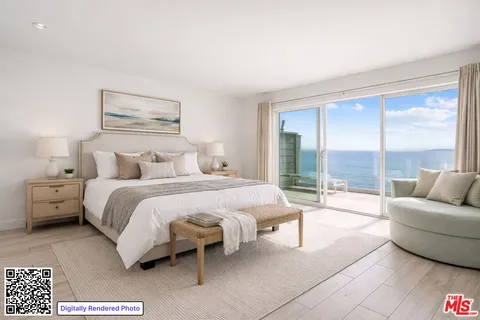 a spacious bedroom with a bed and a large window