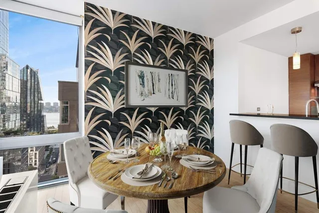 a view of a dinning room with furniture and wooden floor