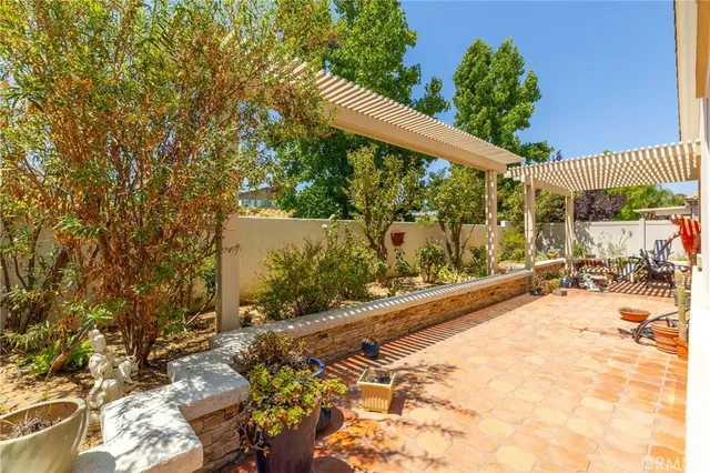 a view of a backyard with plants and a patio