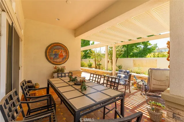 a view of a patio with table and chairs