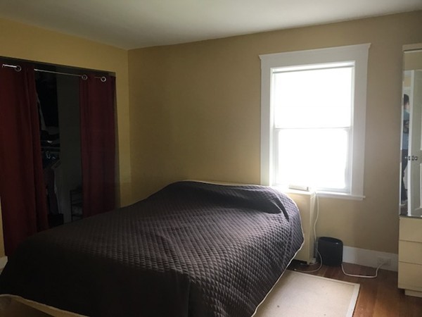 2 Jackson Road Medford, MA 02155 - Photo 14 of 23 a bed sitting in a bedroom next to a window
