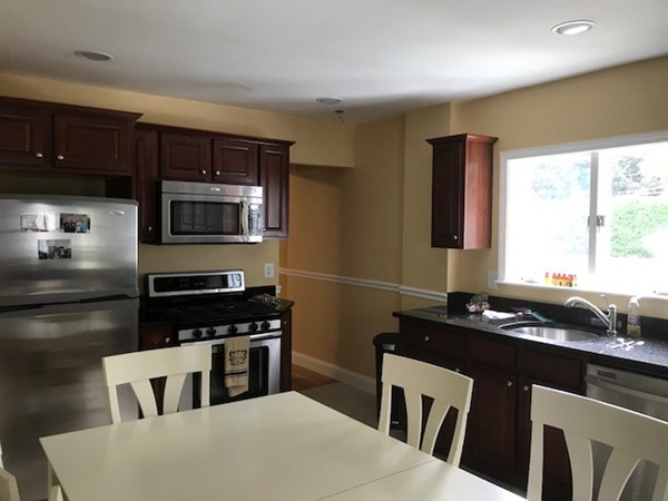 2 Jackson Road Medford, MA 02155 - Photo 8 of 23 a kitchen with a sink a microwave and cabinets